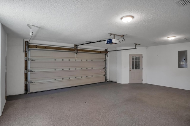 garage with a garage door opener and electric panel