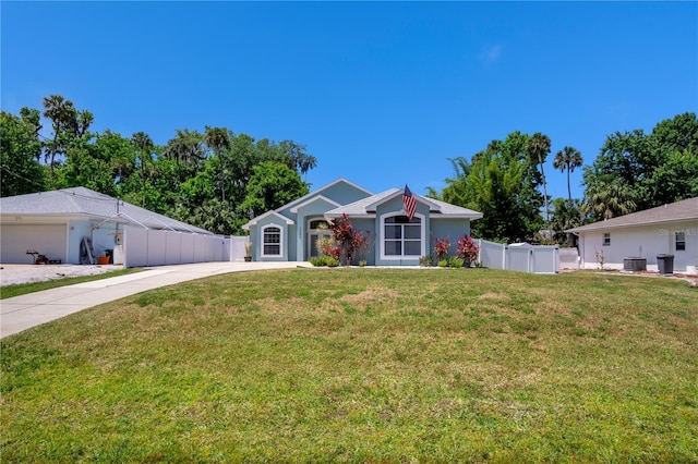 ranch-style home with cooling unit, a garage, and a front yard