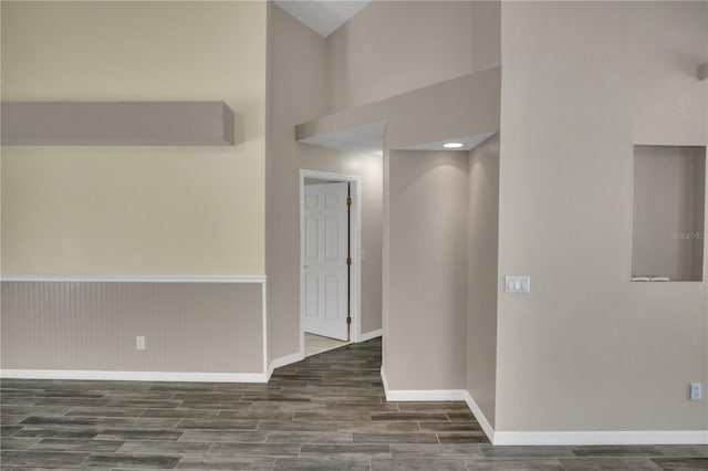 corridor featuring a towering ceiling