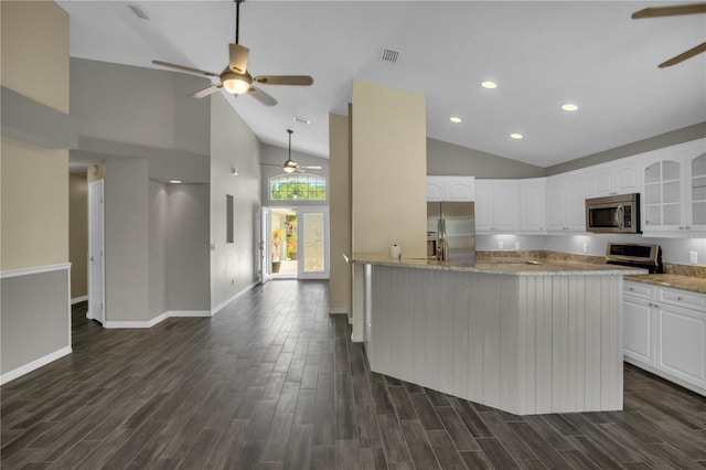 kitchen with white cabinetry, ceiling fan, appliances with stainless steel finishes, and light stone counters