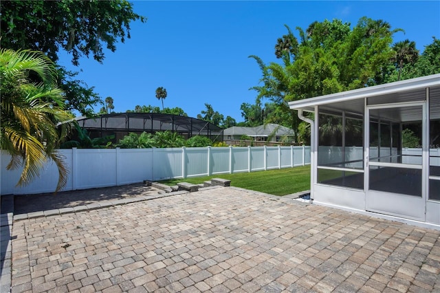 view of patio with a sunroom