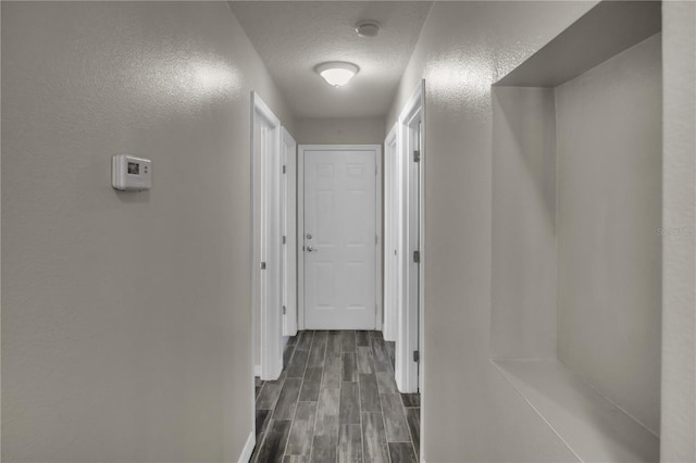 hall with a textured ceiling