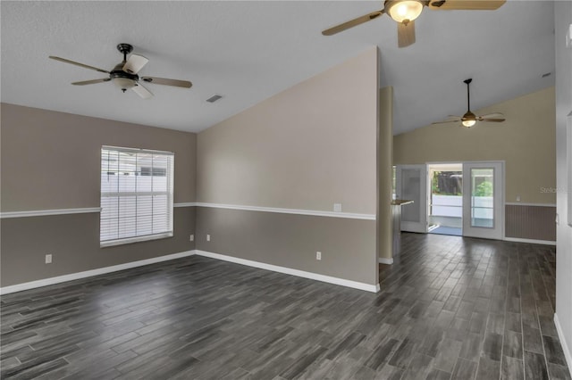 empty room featuring vaulted ceiling and dark wood-type flooring