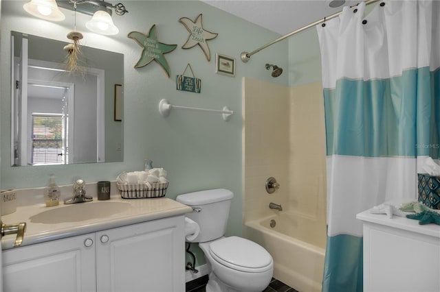 full bathroom featuring toilet, vanity, and shower / bathtub combination with curtain