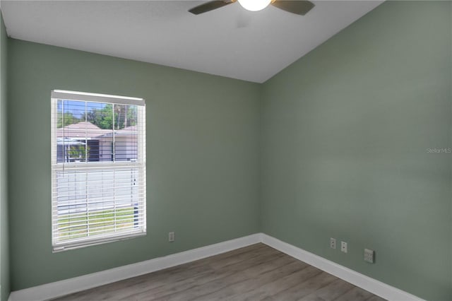 spare room with lofted ceiling, hardwood / wood-style floors, and ceiling fan