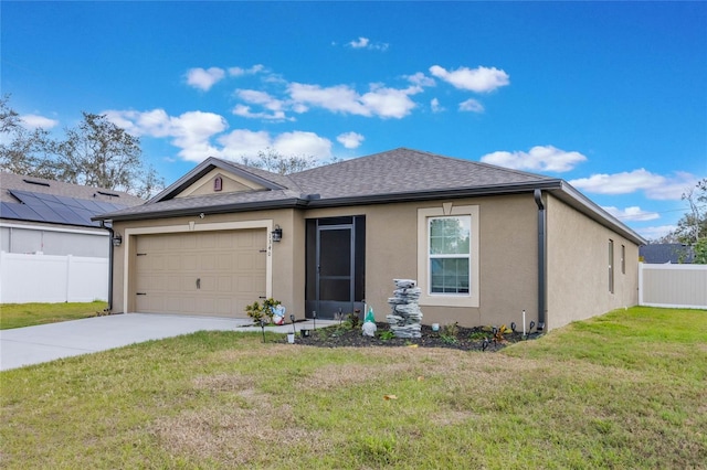 view of front of house with a garage and a front lawn