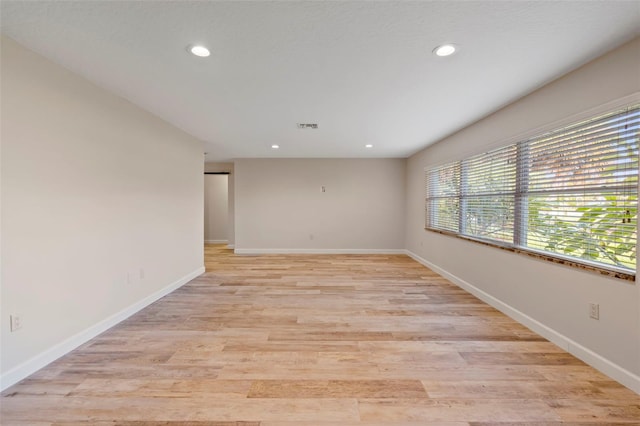 spare room with light hardwood / wood-style flooring