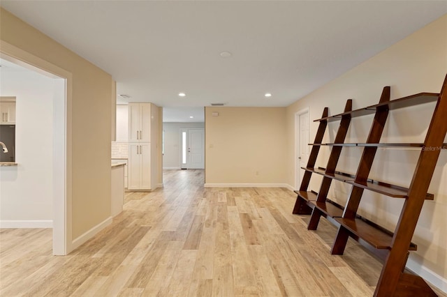 interior space featuring sink and light hardwood / wood-style floors