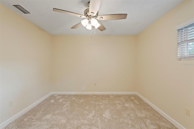 carpeted empty room featuring ceiling fan