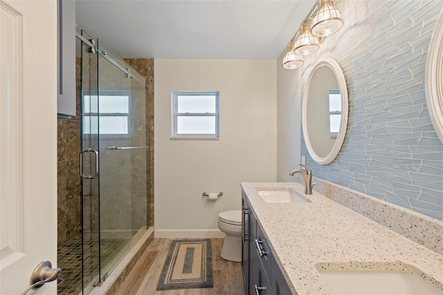 bathroom featuring an enclosed shower, hardwood / wood-style floors, vanity, and toilet