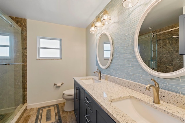 bathroom featuring a shower with shower door, a healthy amount of sunlight, decorative backsplash, and toilet