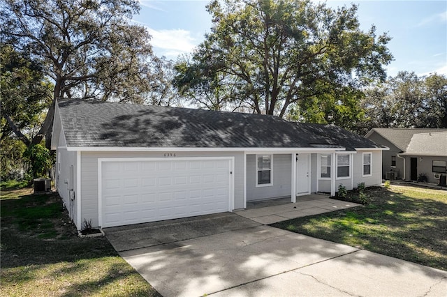 ranch-style house with a shingled roof, a front yard, a garage, cooling unit, and driveway