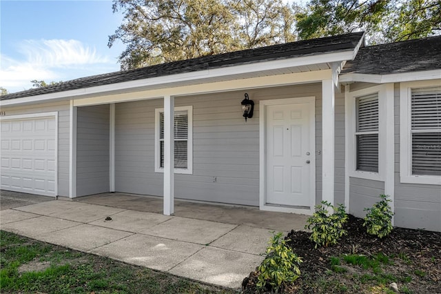 entrance to property with roof with shingles