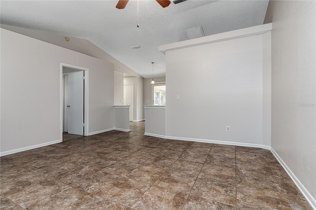 spare room with visible vents, a ceiling fan, vaulted ceiling, a textured ceiling, and baseboards