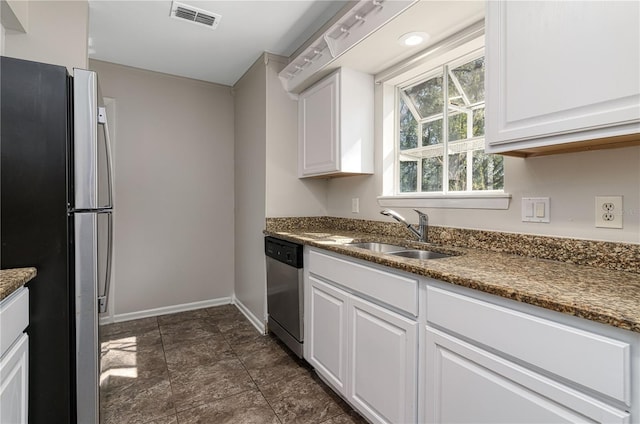 kitchen with white cabinetry, visible vents, stainless steel appliances, and a sink