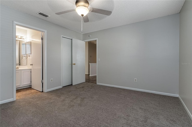 unfurnished bedroom with light carpet, baseboards, visible vents, and a textured ceiling