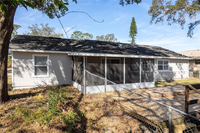 rear view of property with a sunroom