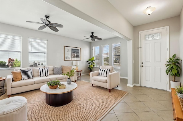 tiled living room with ceiling fan