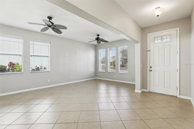 tiled foyer entrance with ceiling fan