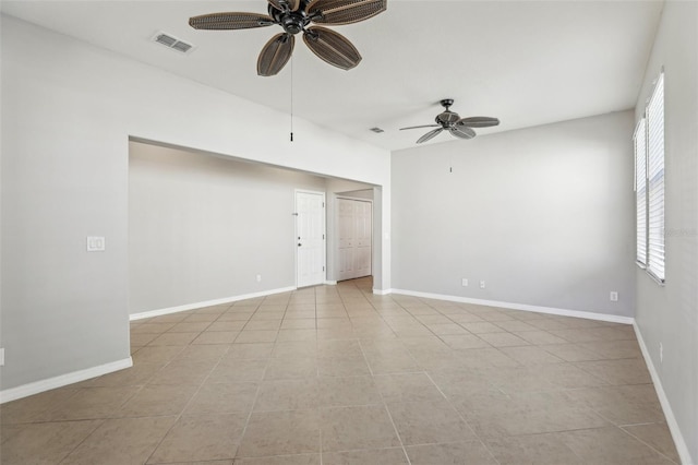 tiled empty room featuring ceiling fan