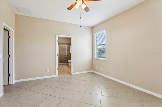 unfurnished bedroom with ceiling fan, connected bathroom, and light tile patterned floors