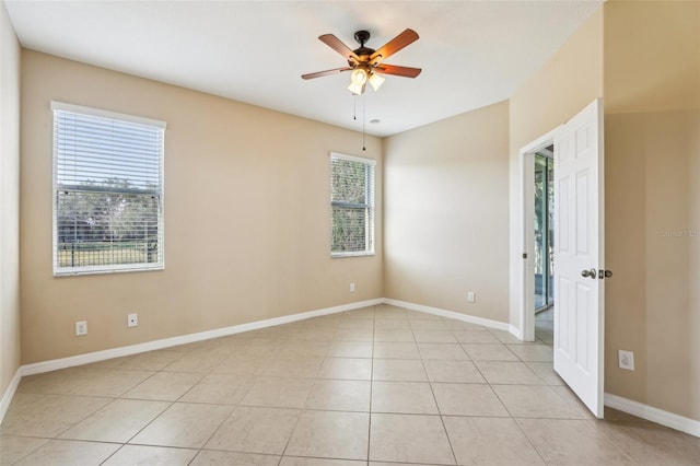 tiled empty room with ceiling fan