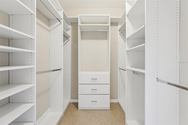 walk in closet featuring light tile patterned flooring