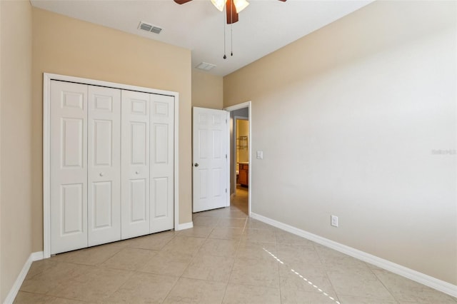 unfurnished bedroom featuring light tile patterned floors, ceiling fan, and a closet