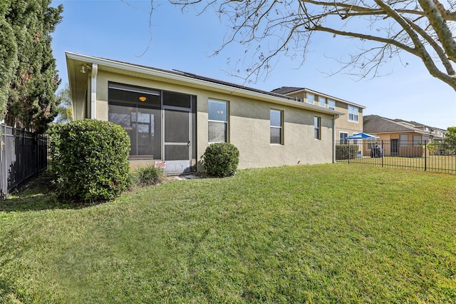 rear view of property with a yard