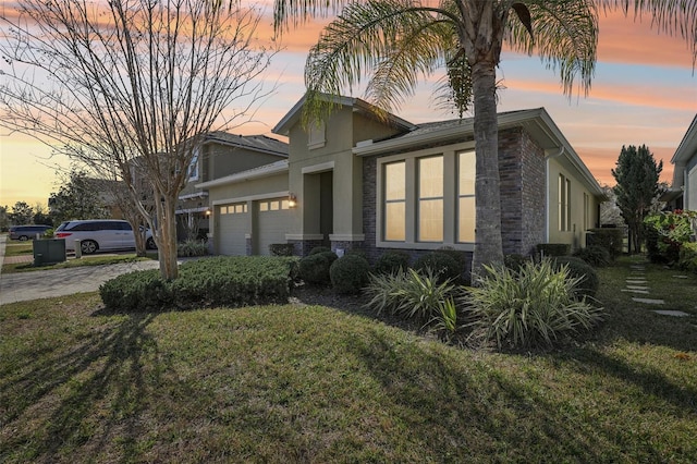 view of front of house with a garage and a lawn