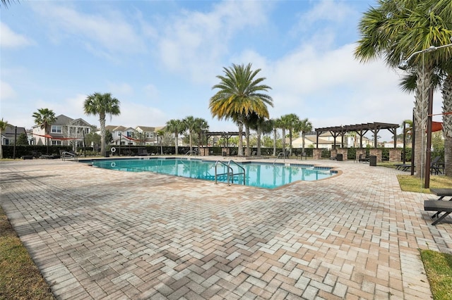 view of pool with a pergola and a patio