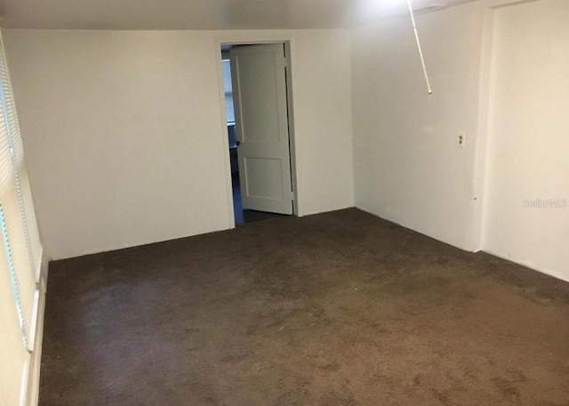 empty room with dark carpet