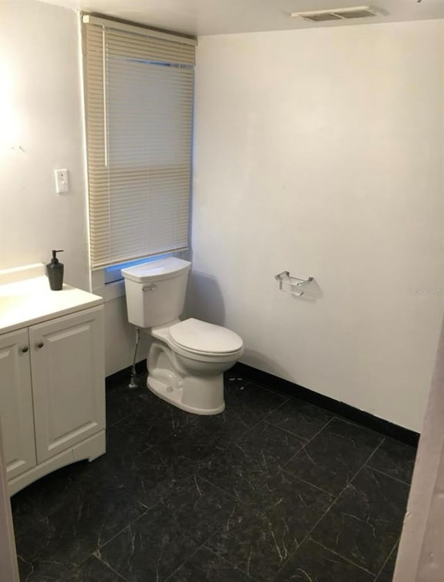 bathroom with vanity and toilet