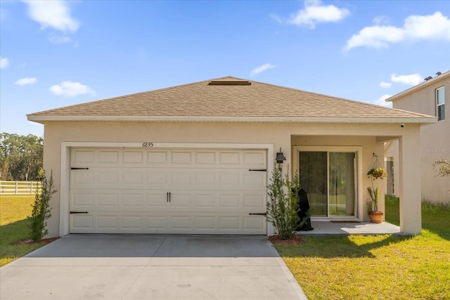 view of front facade with a garage and a front yard