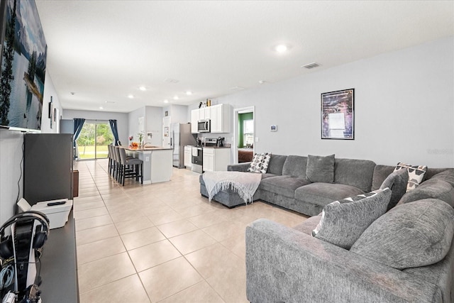 living room featuring recessed lighting, visible vents, and light tile patterned floors