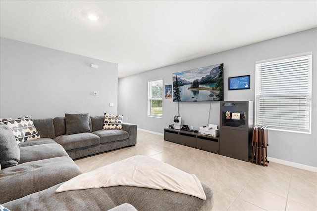 living area with baseboards and tile patterned floors