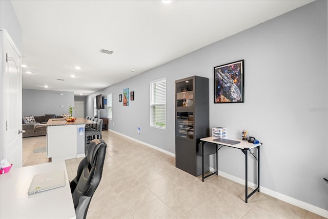 office featuring light tile patterned floors, recessed lighting, visible vents, and baseboards