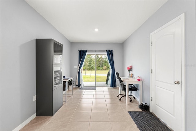 office area featuring light tile patterned flooring and baseboards