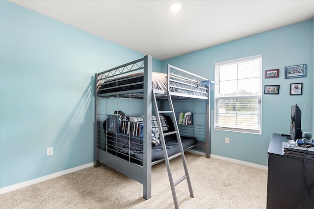 bedroom featuring carpet floors and baseboards