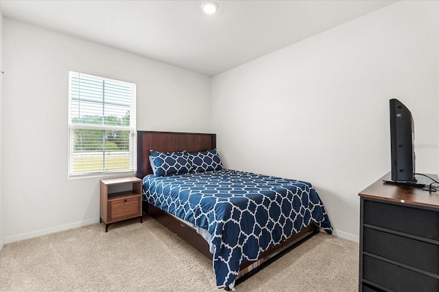 bedroom with carpet and baseboards