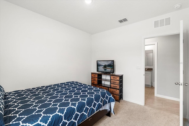 bedroom featuring visible vents, light carpet, and baseboards