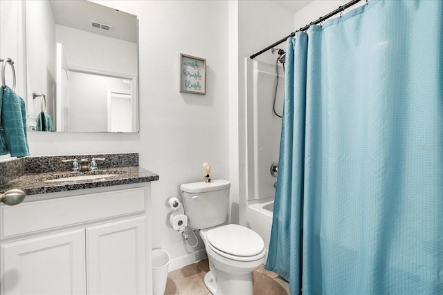 bathroom featuring visible vents, toilet, shower / tub combo, vanity, and baseboards