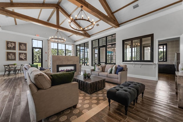 living area featuring wood finished floors, visible vents, a fireplace, and an inviting chandelier