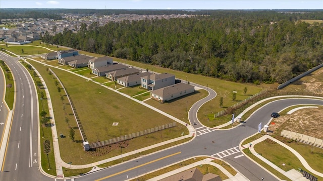 drone / aerial view with a residential view and a view of trees