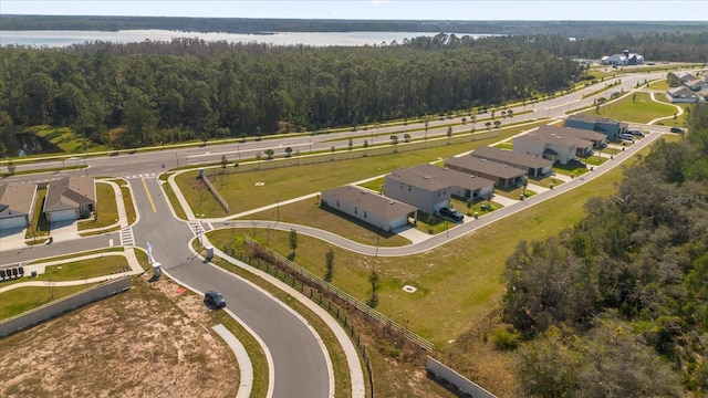 aerial view with a forest view, a water view, and a residential view