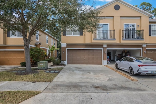 view of property with a balcony and a garage