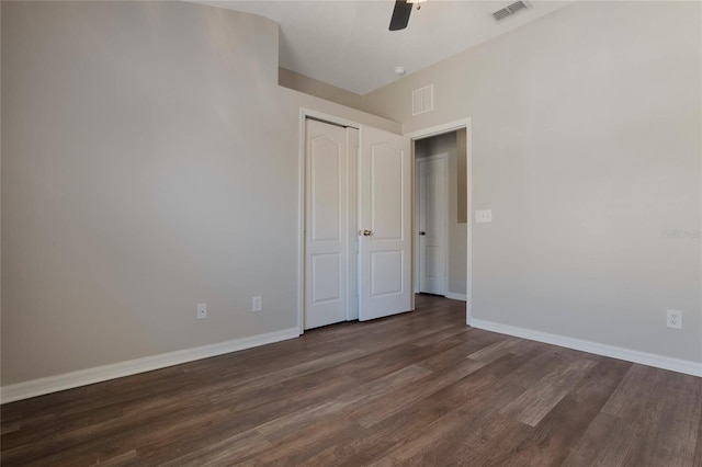 unfurnished bedroom with ceiling fan, dark hardwood / wood-style floors, and a closet