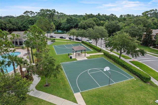 view of basketball court featuring a yard