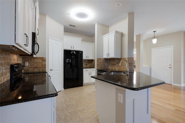 kitchen featuring black appliances, white cabinetry, sink, backsplash, and kitchen peninsula