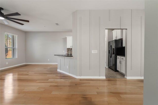 interior space featuring ceiling fan, sink, and light hardwood / wood-style floors